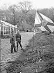 Regimental Sergeant-Major J.L. McNeil and Sergeant K.P. Grant raising the regimental flag of The North Nova Scotia Highlanders for the first time in Germany. Wyler, Germany, 19 November 1944 November 19, 1944.