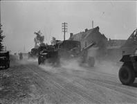 British Artillery vehicles moving up along Falaise road between Vaucelles and Lorguichon 9 Aug. 1944