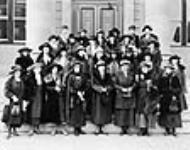 Canadian Women's Press Club, First Regional Group. L. to r.: P.J. Deachman, Gordon, E. Baker, Stewart, A.M. Derrett, M. Gellis, J.M. Shark, M.B. McLaren; M. O'Connor, M. Seymore, E. Murphy, M. Garnett, E. Griffis, H. Aslebrock, (Cont'd in NOTES) 1920