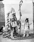 Hayter Reed, Deputy Superintendent General of Indian Affairs, and his stepson, Jack Lowery, dressed in Indian costumes for a historical ball on Parliament Hill février 1896.