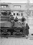 A Dutch girl offering coffee to the crew of a Sherman tank of the South Alberta Regiment, Bergen op Zoom, Netherlands, 29 October 1944 October 29, 1944.