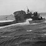 Whaler from H.M.C.S. CHILLIWACK alongside captured German submarine U-744 6 Mar. 1944
