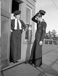 Unidentified signallers of the Women's Royal Canadian Naval Service (W.R.C.N.S.) and Royal Canadian Navy (R.C.N.) comparing bellbottom trousers, Vancouver, British Columbia, Canada, 22 February 1944 February 22,1944.