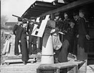 Defensively Armed Merchant Sips (D.E.M.S.) personnel learning to fire an Oerlikon 20mm anti-aircraft gun, Esquimalt, British Columbia, Canada, 15 March 1944 Marh 15, 1944.