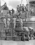 Commandos loading ammunition aboard a Landing Craft Assault (LCA) of H.M.C.S. PRINCE DAVID near Taranto, Italy, 13 September 1944 September 13, 1944.