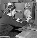An unidentified member of the Women's Royal Canadian Naval Service (W.R.C.N.S.) operating direction-finding equipment at H.M.C.S. COVERDALE, Riverview, New Brunswick, Canada, August 1945 August 1945.