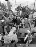 An injured German seaman being taken aboard H.M.C.S. PRINCE DAVID in the Mediterranean Sea, August 1944 August 1944.
