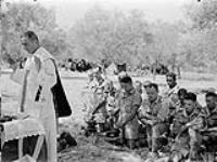 H/Captain J.S. Mullaney conducting a mass for troopers of the First Canadian Army Tank Brigade in Sicily, Italy, 8 August 1943 August 8, 1943.