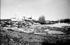 Flood at Hay River. Fill 'A'. EXPEDITOR on bank 1951