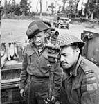 Sergeant D. Mills and Gunner H.W. Embree checking the gunsight of a Priest M-7 105mm. self-propelled gun of the 14th Field Regiment, Royal Canadian Artillery (R.C.A.), France, 20 June 1944 June 20, 1944.