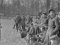 Personnel of the 1st Battalion, The Canadian Scottish Regiment, watching a sports meet in the Hochwald, Germany, 19 March 1945 Marh 19, 1945.