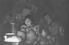 [Kunuk (wife) and Tagurnaaq (husband) with their children Sarpinak and Tukturjuk.] ca. 1953