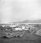 Grounded ice floes with tents and komatik July 1951.