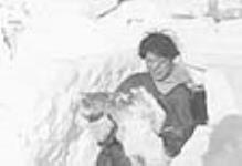 [Kinaryuaq holding caribou meat for lunch.] 1950