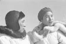 Close-up photograph of an Inuit man and woman wearing hats and parkas outside at Inukjuak, Nunavik (Quebec) [Josie (Juusi) Nowra (left) and Martha (née Nulukie) Nowra (right)] 1947-1948.
