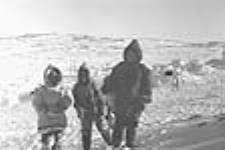 Four Inuit children in front of camp, Inukjuak (Port Harrison), Quebec 1947-1948.