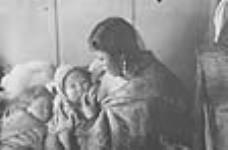 [(Left to right): Qupak, Pemik, and Yarat. Yarat is breastfeeding Pemik] 1950