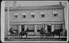 Commercial House, showing two horse-drawn carriages and children in front of the building. Believed to house the offices of the 'Sentinel Star' ca. 1870's