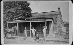 First newspaper office showing four men in front ca. 1860's