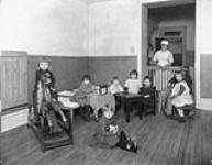 Nurse and children at the Ottawa Day Nursery (known since 1970 as the Andrew Fleck Child Centre) ca. 1925.
