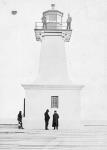 Concrete lighthouse tower completed (painter is still holding paint and brush) 1904