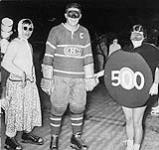 Montreal Canadiens' Dick Bacon with a young woman disguised as hockey puck 500 ca. 1950's