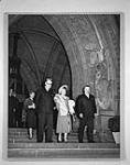 H.M. Queen Elizabeth the Queen Mother on the steps of the Centre Block. Mr. W. Howard Measures is at left in the background n.d.
