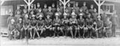 Staff of the Musketry School. (Front row, left to right: Lt. Lawren Harris (third from left and first one seated), Maj. Vincent Massey (seventh from left and fifth one seated). (Rear row: Sgt. W. Howard Measures (tenth from left) Aug. 1916