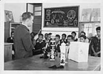 Robert N. Thompson, Headmaster H.S.1 Secondary School with a group of students during biology class 1944