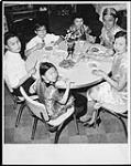 Mr. and Mrs. Kwok Sun Louie, immigrants to Canada from Hong Kong in 1954, have Chinese New Year dinner with their family c.a. 1962