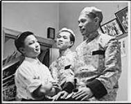 Each member of the family wears something new for dinner at Chinese New Year. L-R: Henry Louie, 15, friend John Wong, father Kwok Sun Louie, who emigrated to Canada from Hong Kong in 1954 c.a. 1962