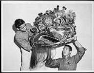 George Lum, arts, and Gene Thom, engineering with the head of King Lion, used at the University of British Columbia's annual international Fall Fair Nov. 1960