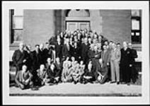 Staff of the Dominion Observatory and the Geodetic Survey on the steps at the southside door of the Geodetic Survey Building 28 Nov. 1939