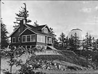 Exterior view of the Dominion Astrophysical Observatory site - photo includes house of astrophysicians ca. 1916-1917