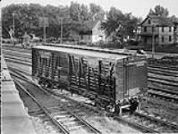 Box car number 20349 of the C.C.C. & St.L of the New York Central Lines in station showing houses in background ca. 1910-1920