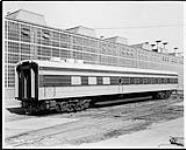 Passenger car No.109 of THE MILWAUKEE ROAD in front of shops? 30 Aug. 1938