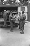 Personnel of a Casualty Clearing Station of the Royal Canadian Army Medical Corps (R.C.A.M.C.) evacuating "casualties" during a training exercise with the Home Guard, Lingfield, England, 16 June 1942 June 16, 1942