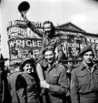 Sergeant Karen M. Hermiston of the Canadian Army Film and Photo Unit during VJ-Day celebrations in Piccadilly Circus, London, England, 10 August 1945 August 10, 1945.