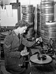 Sergeant Margaret O. King of the Canadian Army Film and Photo Unit operating an editing machine in the film library at Merton Park Studios, London, England, 19 December 1944 Deember 19, 1944