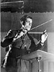Unidentified conductor leading orchestra during a CBC radio broadcast of The Army Show 21 Jan. 1944