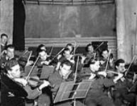 The string section of the orchestra during the Canadian Army Show Broadcast, London, England, 29 June 1945 June 29, 1945.