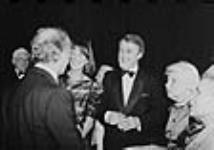 Mr. Brian Mulroney and Mrs. Mila Mulroney speaking to Prime Minister Pierre Elliott Trudeau at the gala event for the swearing-in of the Governor-General Jeanne Sauvé held at the National Art Centre 1984