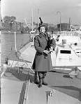 Piper Flossie Ross of the Canadian Women's Army Corps (C.W.A.C.) Pipe Band on the deck of a surrendered German "E"-boat, Wilhelmshaven, Germany, 4 October 1945 October 4, 1945.