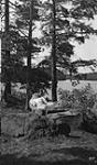 Unidentified woman resting in hammock, Craigie Lea, Muskoka Lakes ca. 1907