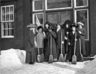 Group of women curlers in front of the Rideau Curling Club ca. 1910