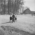 Civilians en route to churchyard during fighting between German paratroopers and personnel of the 4th Canadian Armoured Division 10 Apr. 1945