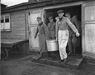 Concentration camp - internees from each compound pick up food at kitchen for their own compound 30 Ot. 1945