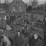 4th Canadian Armoured Division's drive towards Oldenburg. General view of German prisoners held in emergency P.O.W. cage in churchyard 10 Apr. 1945
