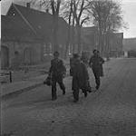 4th Canadian Armoured Division's drive towards Oldenburg. After fall of Sogel, German prisoners are escorted to P.O.W. cage 10 Apr. 1945