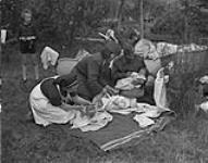 Nine babies were born at the Polish Army womens Prisoner of War Camp. Three of the mothers and their children are shown here 7 May 1945